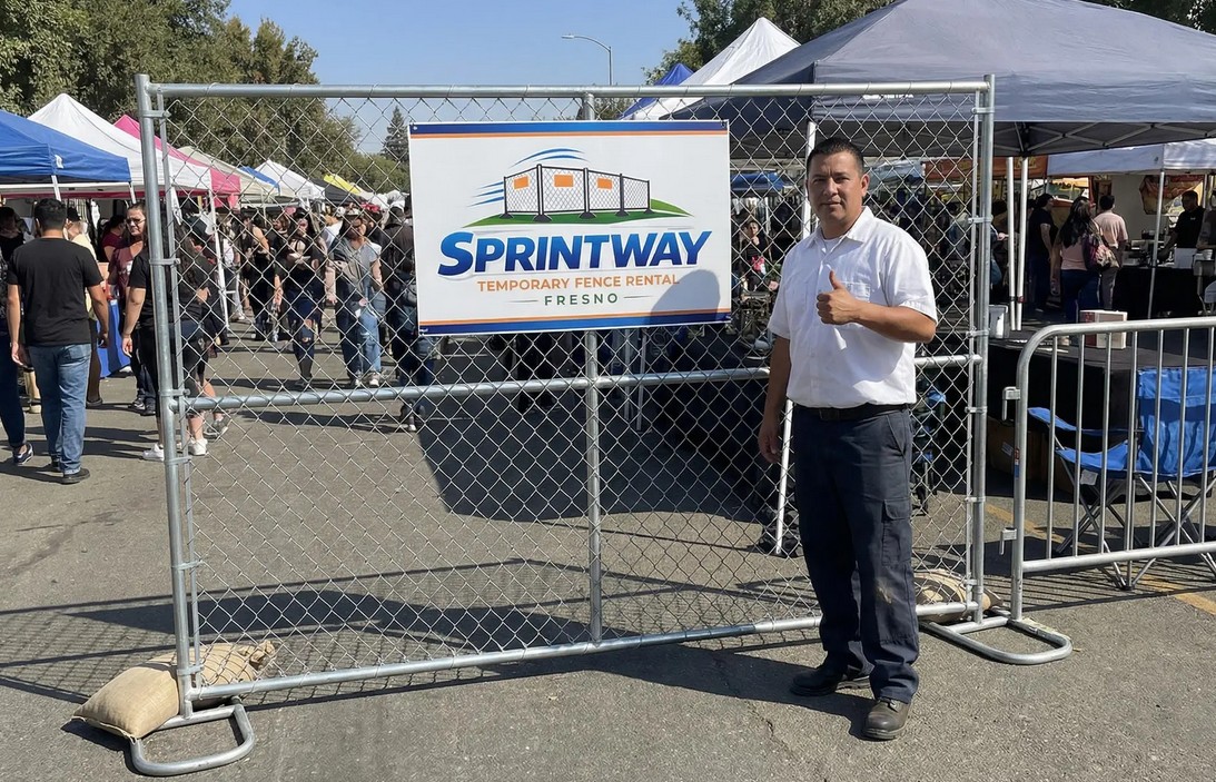 Sprintway Temporary Fence Rental Fresno team member standing next to installed chain link temporary fence panels